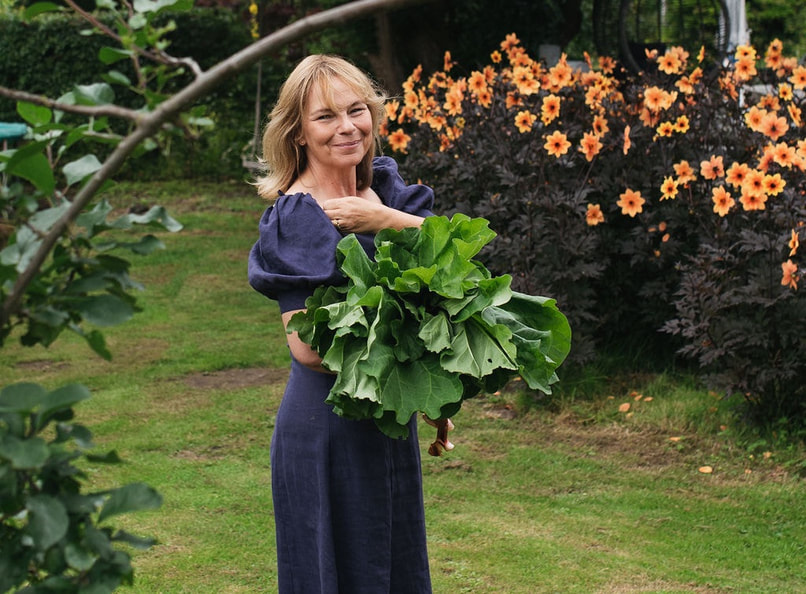 Fiona in garden with organic vegetables